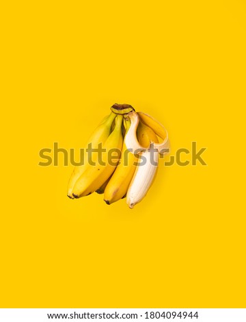 bananas with one of then pealed 