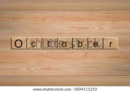 October word written on wood block. Message text on wooden table for backdrop design.