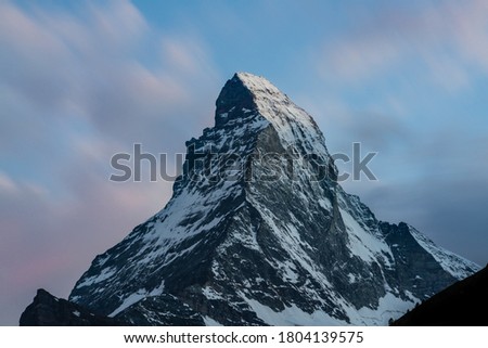 Matterhorn summit beautiful view long exposure shot at sunset with scenic colorful clear sky taken from Zermatt in Swiss Alps Switzerland Royalty-Free Stock Photo #1804139575