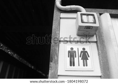Toilet signs for man and woman or toilets. Written in Thai and English alphabet. black background. Selective focus