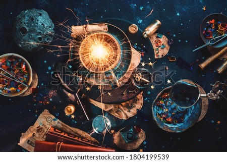 Supernova in a tea cup, handmade ceramic cup with bright light inside, astrology flat lay with scrolls and stars Royalty-Free Stock Photo #1804199539