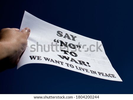 Say NO to war. We want to leave in peace. Message written on a banner held in the hand- Concept for peace, against war