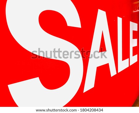 Big red background with white sale word signage in perspective view