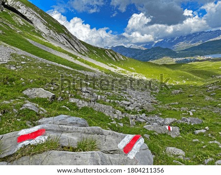 Mountaineering signposts and markings on the slopes of the Melchtal alpine valley and in the Uri Alps mountain massif, Kerns - Canton of Obwalden, Switzerland