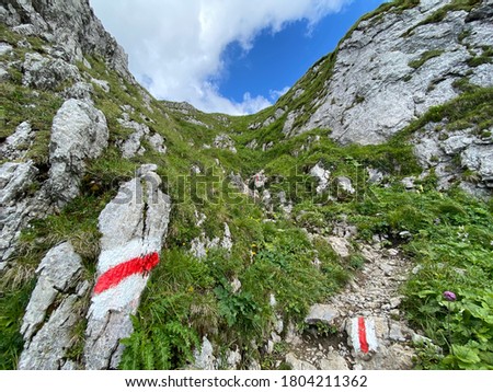 Mountaineering signposts and markings on the slopes of the Melchtal alpine valley and in the Uri Alps mountain massif, Kerns - Canton of Obwalden, Switzerland