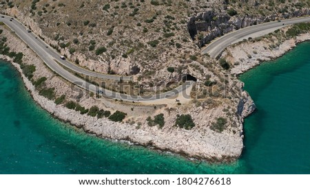Aerial drone photo of Tunnel in Athens riviera seaside road known as hole of Karamanlis or "Tripa of Karamanlis", Attica, Greece