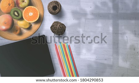 Colorful Straws and Tablet on White Background – Top View