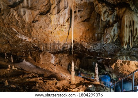 Long thin limestone stalactite and opposite stalagmite in Punkva Caves, Moravian Karst, Czech Republic. Royalty-Free Stock Photo #1804299376
