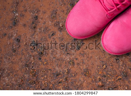 Autumn Fashion Concept. Pink leather women boots  on brown iron background top view copy space. Autumn shoes.