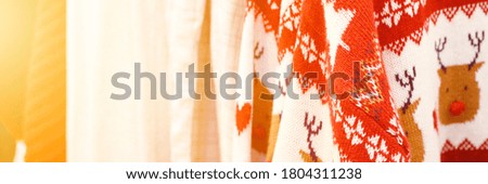 winter Christmas knitted and cotton clothing in white and red colors. banner. flare
