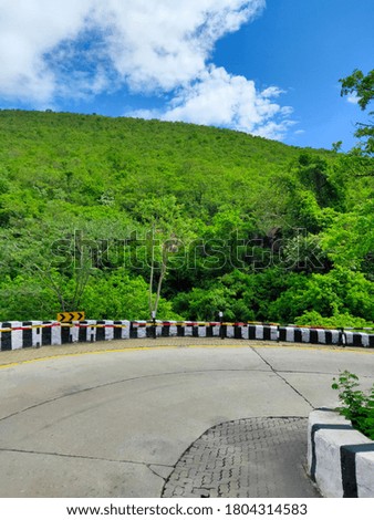A beautiful nature picture containing road and mountain greenery in thirupathi 