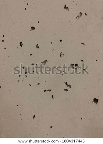 gray concrete textured wall with holes