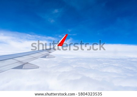 Aircraft wing with blue sky and cloudy sunrise on the airplane. picture for add text message or frame website. Traveling and Transport concept.