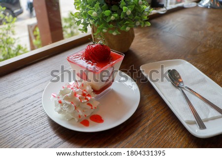 Strawberry mousse served with whipped cream