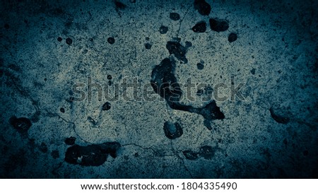 Textured blue vignetted concrete surface background with space for text