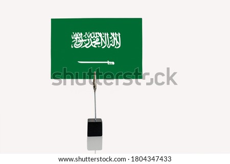Absolute Monachy of Saudi Arabia miniature flag in cube base in photograph holder on a white background