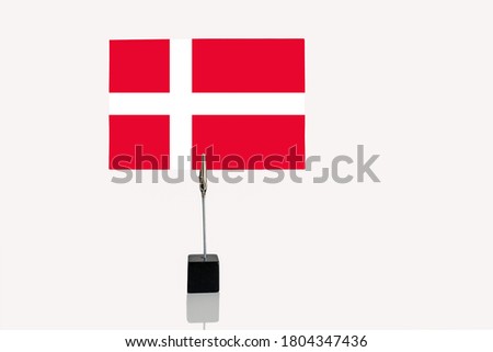 Kingdom of Denmark miniature flag in cube base in photograph holder on a white background