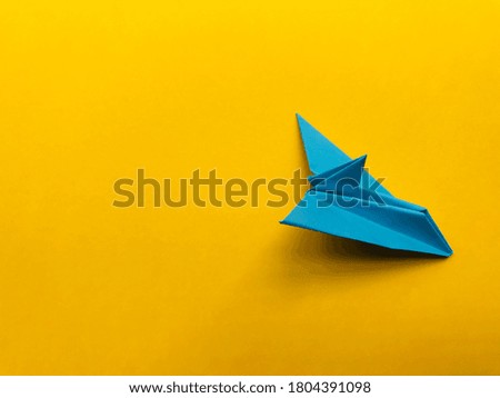 Blue Paper airplane vector on yellow background / origami