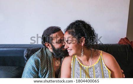 Happy indan couple wearing traditional dress and having a tender moment together at home - Concept of marriage and love - Focus on the forehead of the woman