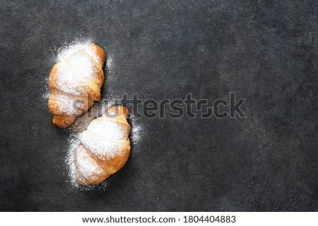 Croissants on a black concrete table. View from above.