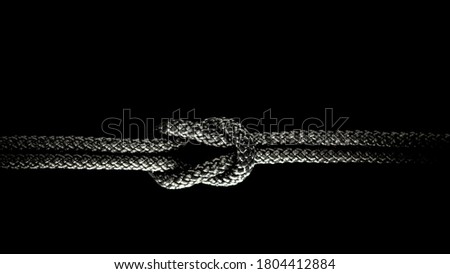 Reef knot black rope on a black background.