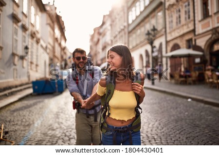 Young smiling man and woman at the Prague.Happy tourists travelling and enjoying on vacation,
