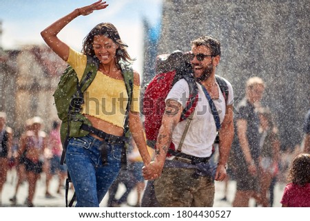 Romantic  raining day at summer  vacations.Happy  woman and men traveling and enjoying  together