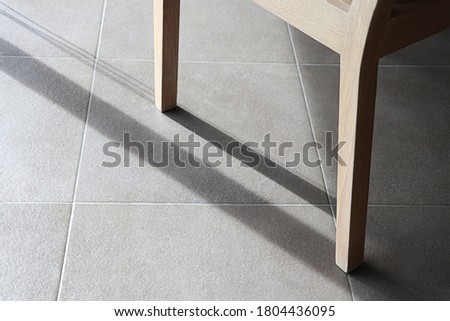 Detail of teak wood furniture, Closeup dining chair on the floor Royalty-Free Stock Photo #1804436095