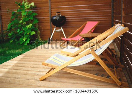 recreation area in the yard of the house: chairs, barbecue, table