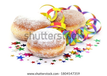 Donuts and paper streamers on white background, isolated.