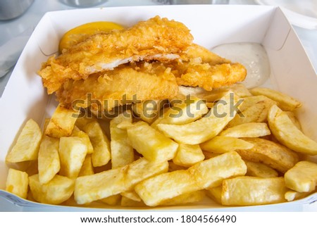 Fresh Scottish haddock deep fried in light, crispy batter. Royalty-Free Stock Photo #1804566490