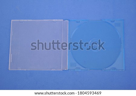 Acrylic cover for compact disc or Digital Versatile Disc, on blue background, with top view