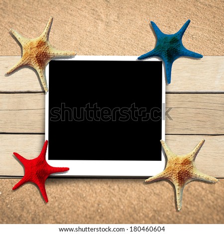 Few marine items on a wooden boards against sandy background.