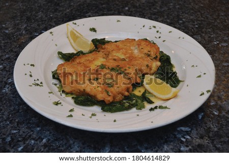 Chicken Francese with lemon juice, egg, butter and garlic Royalty-Free Stock Photo #1804614829