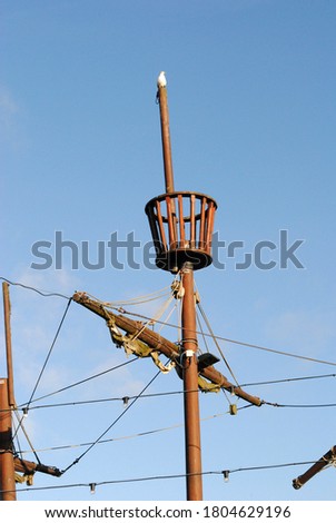 Close Up of Mast & Crows Nest on Children's Wooden Pirate Ship in Playground against Blue Sky Royalty-Free Stock Photo #1804629196
