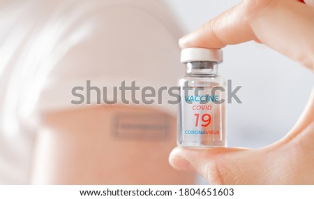 Vial with vaccine for covid-19 coronavirus, flu, infectious diseases. Patient hand with blue stamp vaccinated. Injection after clinical trials for human, child, adult, senior. Medicine,drug concept.