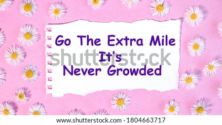 go the extra mile it is never growded. beautiful picture on white paper against a pink background on which there are small daisies all over the surface.