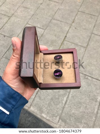 Men's cufflinks Hand-made presentation of gift fashion trend men's fashion inside brown and green boxes Macro Detail shot buying now.