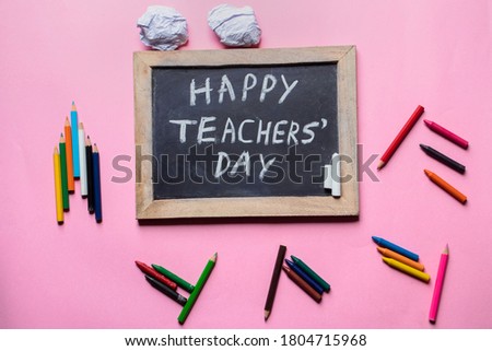 Happy Teacher's Day Creative Photo with Chalkboard and Color Pencils Isolated on Pink Background, Perfect for Wallpaper