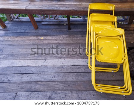 Yellow chair made of sturdy aluminum for relaxing outside the house.