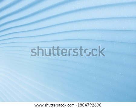 Blue sponge pads that are placed in layers like a wave. Soft focus.