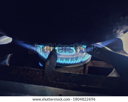 uttarakhand,india-3 june 2020:gas stove with blue flame.this is a picture of a gas stove with blue flame and cooking utensil on it.blue flame on gas stove.