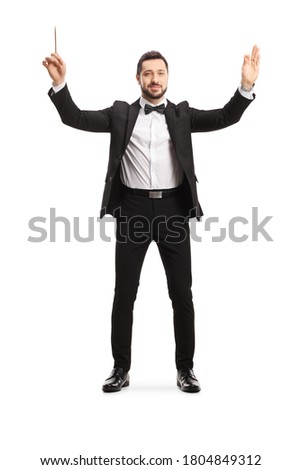 Full length portrait of a male musical conductor starting a show isolated on white background Royalty-Free Stock Photo #1804849312