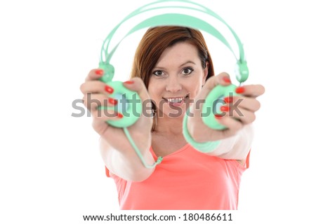 Young attractive red hair  woman in fitness clothes with cell phone and headphones listening to music happy and delighted isolated on White background 