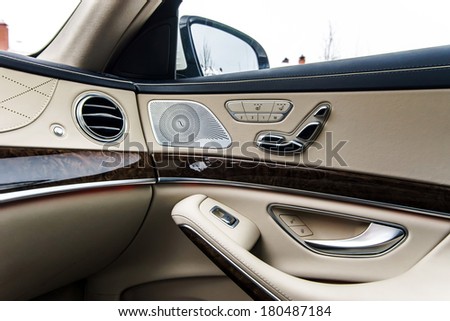 Luxury car interior details. Skin and chromium. Royalty-Free Stock Photo #180487184