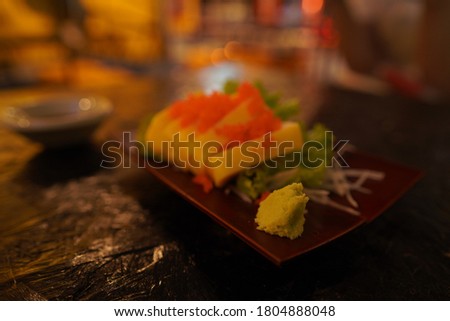 Sushi roll isolated on black background. Sushi japanese food in restaurant. Piece of California Sushi roll set with salmon, vegetables, flying fish roe and caviar closeup IN THAILAND.