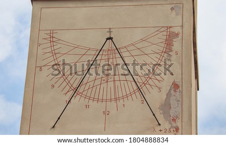 Detail of a sundial in the tower of the church of Saronno, Italy