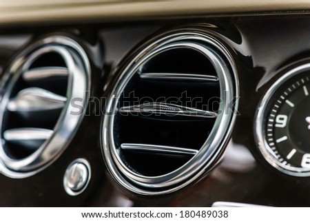 Luxury car interior details. Skin and chromium. Royalty-Free Stock Photo #180489038