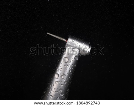 Dental handpiece macro photo with water drops Royalty-Free Stock Photo #1804892743