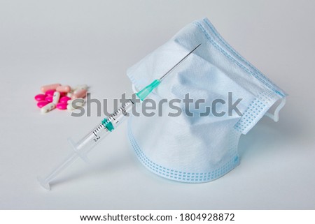 Syringe, Mask and Pill on White Background